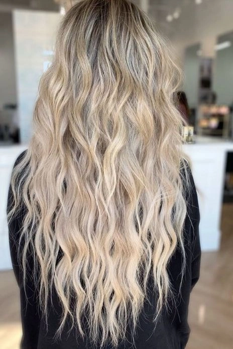 Casual relaxed beach waves perfect for fine hair styles image 4 Woman with relaxed beach wave hairstyle on fine hair in casual outdoor setting