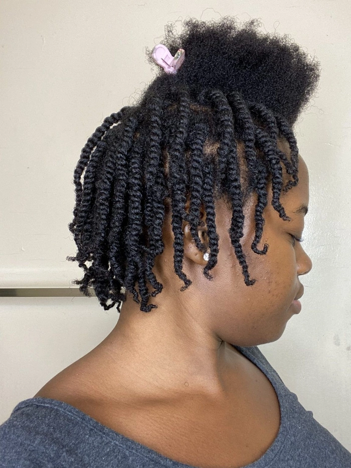Casual relaxed braid out hairstyle for natural coils captured in image 4 Woman with relaxed braid out hairstyle showcasing natural coils in a casual setting