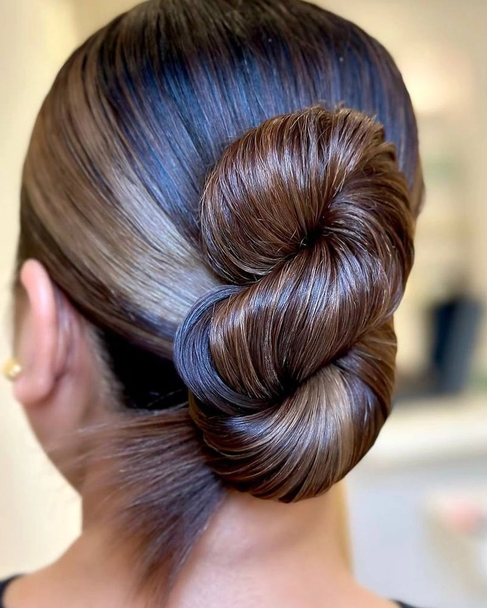 Woman with a relaxed low bun hairstyle perfect for casual looks over 40