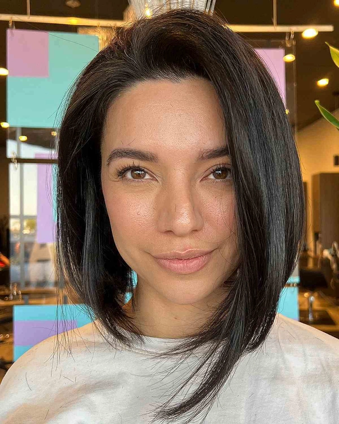 Woman with a relaxed side swept hairstyle on an asymmetrical bob in a casual setting
