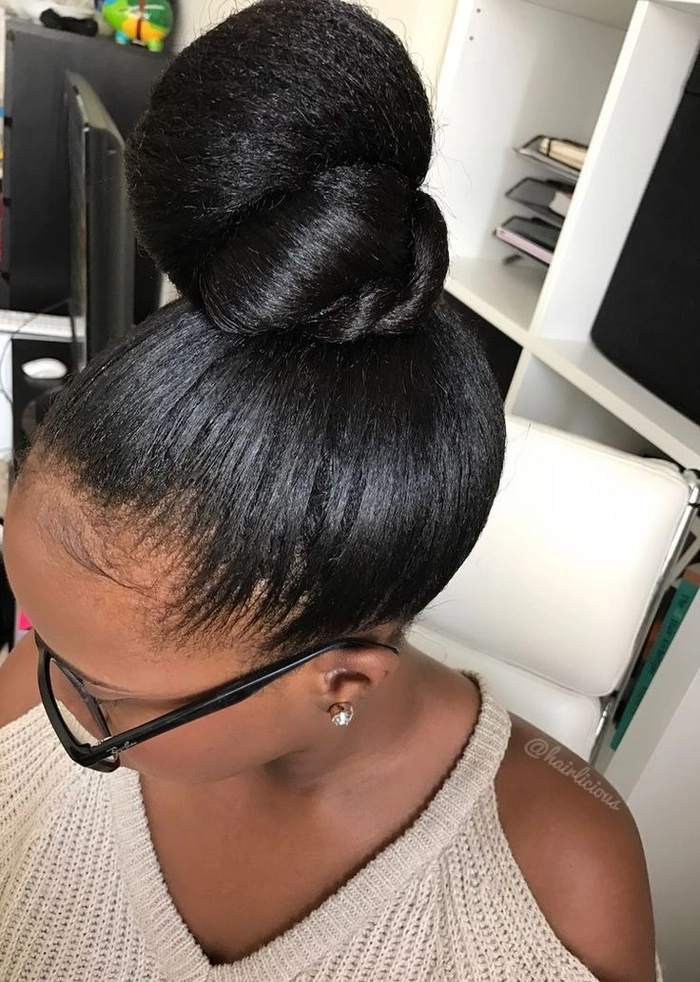 Woman with a relaxed top knot hairstyle perfect for humid weather