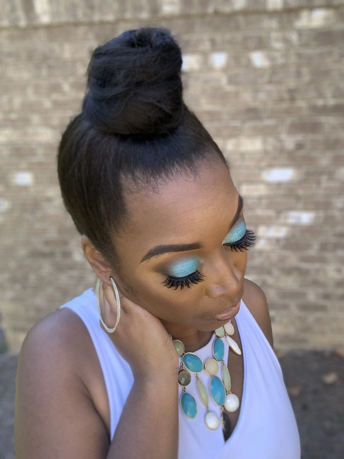 Woman wearing a relaxed top knot hairstyle perfect for humid weather