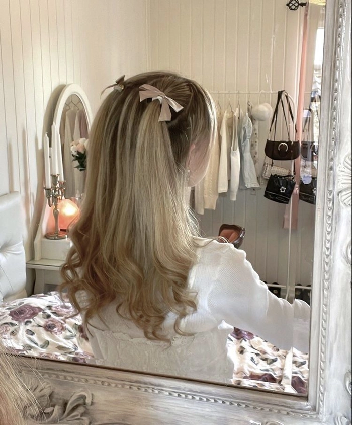 Woman with a quick messy ribbon ponytail style for a coquette casual fashion look