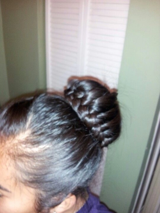 Woman with thick heavy hair styled in an everyday braid and bun combo