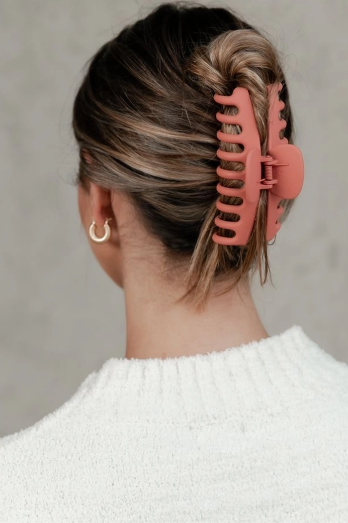 Woman with thick hair styled in a casual quick claw clip hairstyle