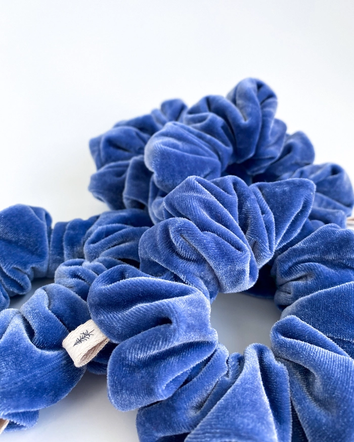 Woman with a simple velvet scrunchie updo for a cozy winter casual look at home
