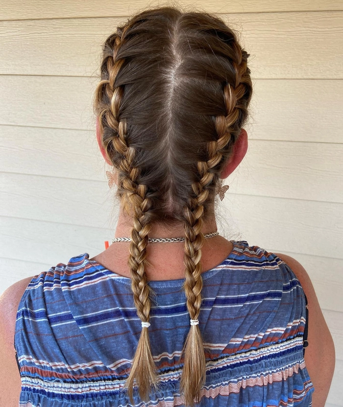 Effortless casual double braids perfect for sporty looks Young woman with casual double braids styled for athletic activities