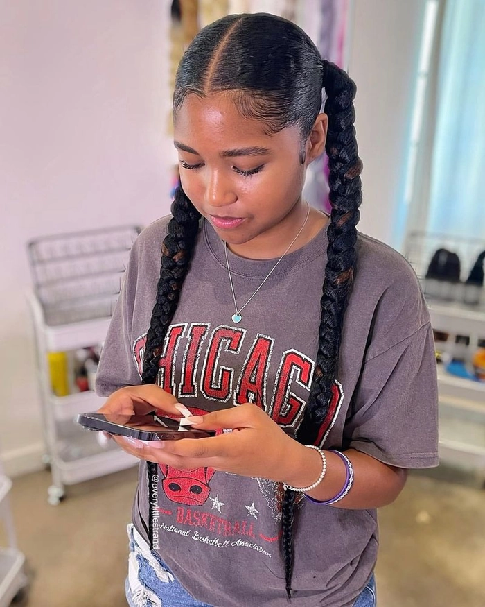 Young woman with casual pigtail braids showing off a youthful everyday look