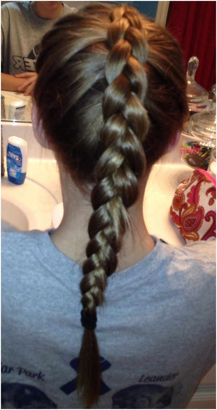 Casual double braids hairstyle perfect for sporty and active days outdoors Young woman with casual double braids styled for athletic activities outdoors