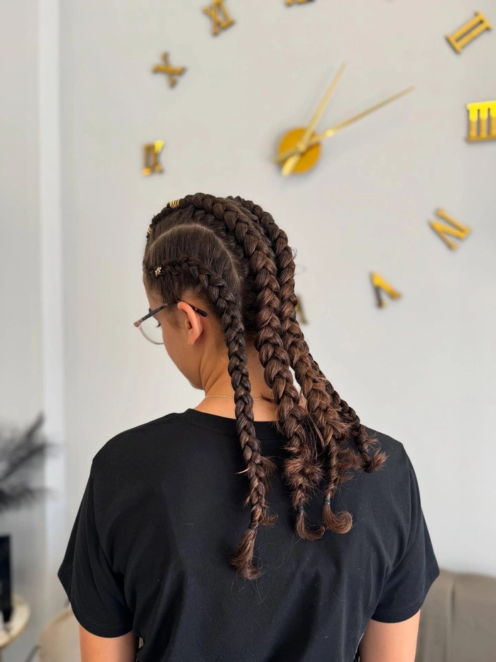 Effortless casual double braids hairstyle ideal for sports and workouts Young woman with casual double braids perfect for athletic activities