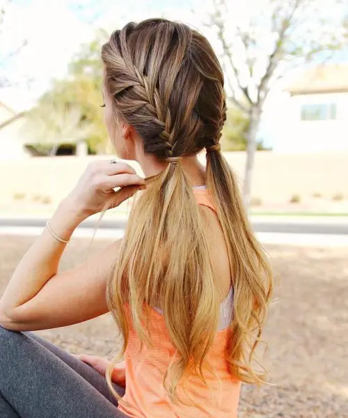 Stylish casual double braids perfect for sports and workouts Young woman wearing casual double braids for athletic activities outdoors
