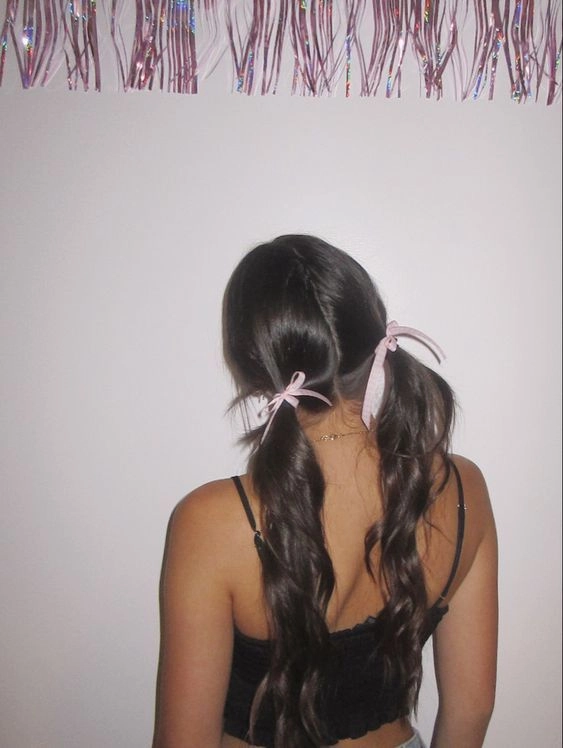 A young woman with a quick, soft ribbon-tied ponytail, embodying coquette casual fashion with a gentle, everyday look