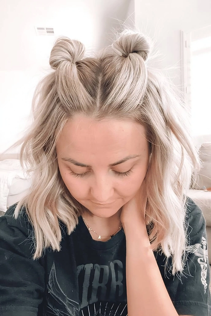 Effortless quick space bun look perfect for casual festival vibes Young woman with quick space bun hairstyle at a lively music festival