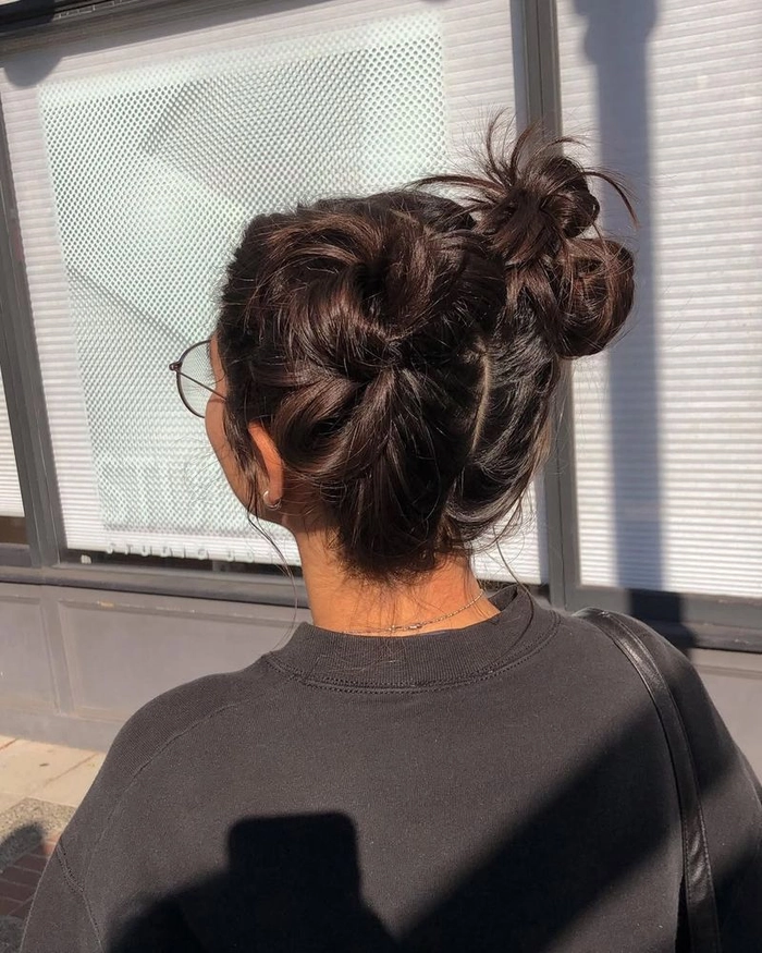 Trendy quick space bun look for casual festival style Young woman with quick space bun hairstyle perfect for music festivals