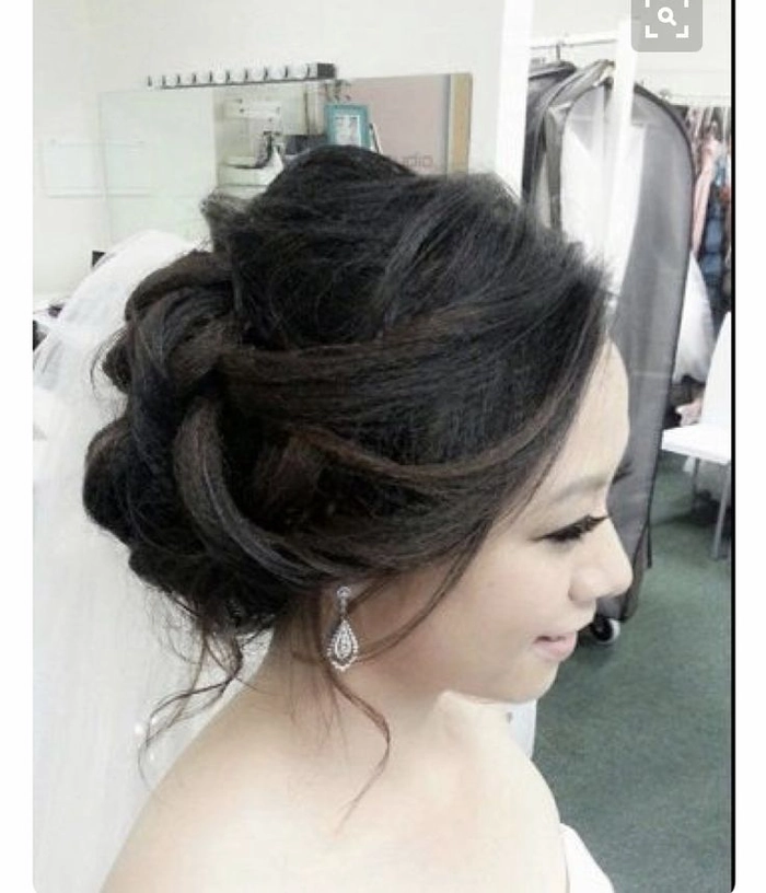 Sleek Asian evening updo with a polished finish and elegant styling for date night