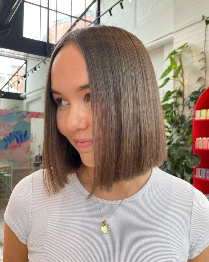 Blunt cut sleek date night style for elegant evening out A model with a sleek blunt cut hairstyle suited for a date night