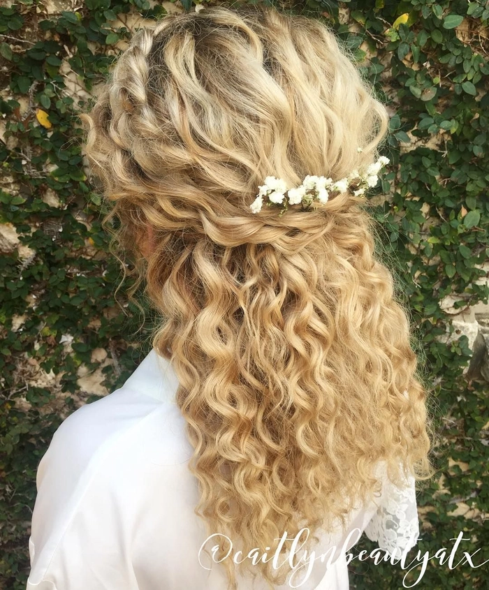 Elegant curly half-up hairstyle perfect for an anniversary dinner