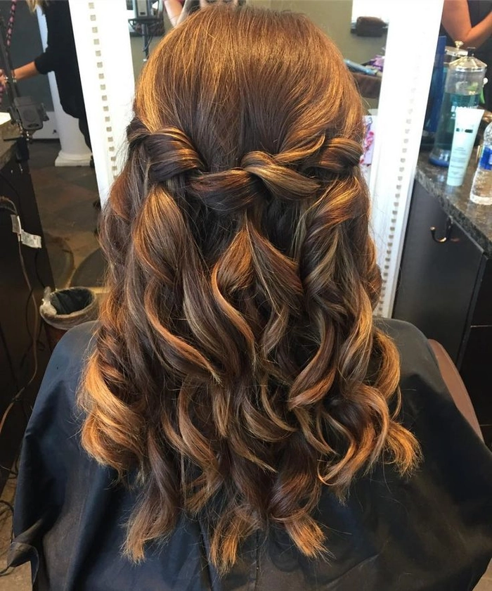 Woman with highlighted hair styled in a romantic updo for an evening date