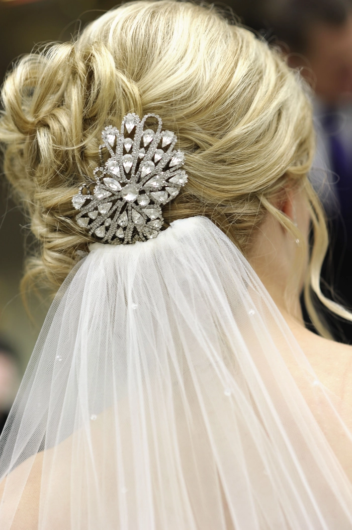 A romantic updo adorned with vintage brooches for a date night look