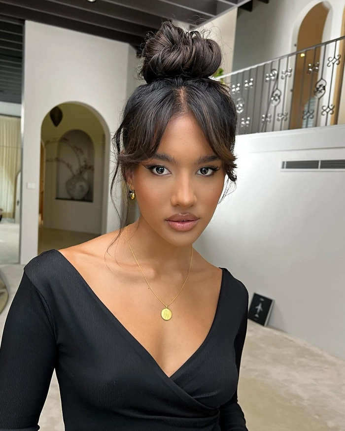 Woman with bangs styled in an elegant updo for a date night