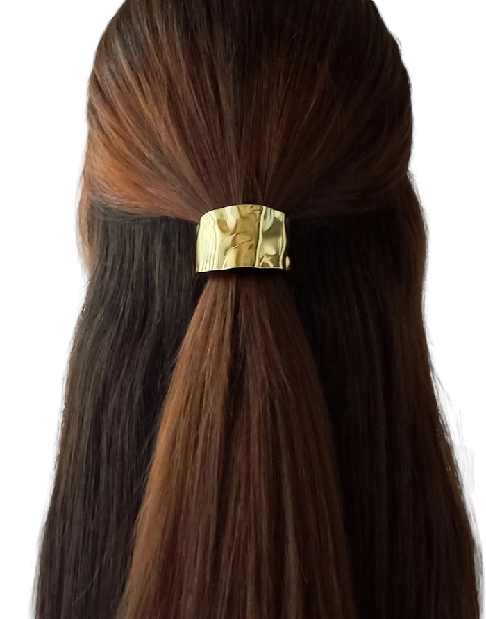 Sleek date night ponytail adorned with metallic hair cuffs
