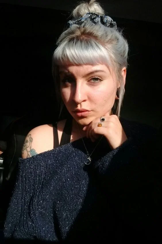 Romantic updo showcasing micro bangs for a date night look