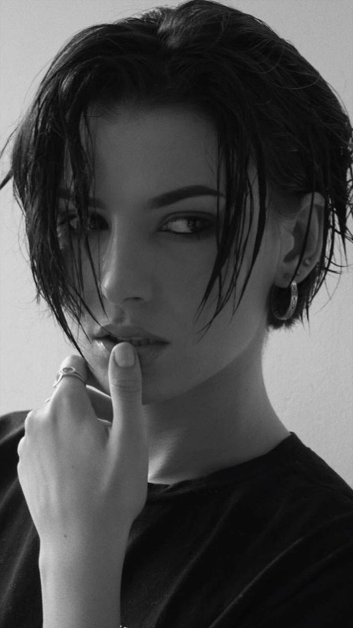 A woman with an edgy slicked back look for evening outings, styled as date night hair