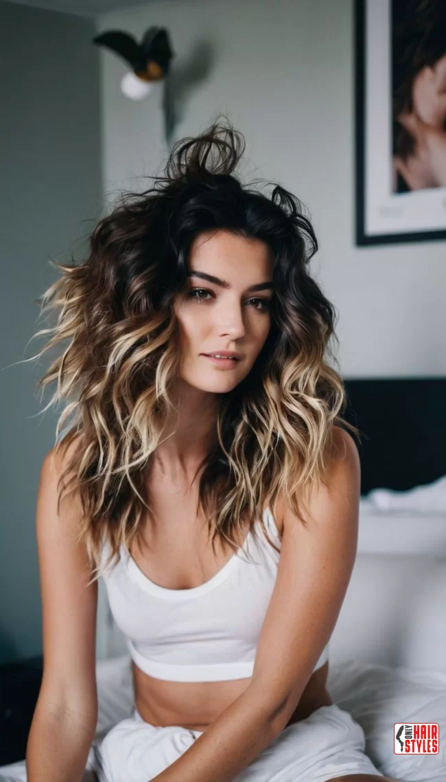 A woman with relaxed, tousled bedhead waves styled for a cozy movie night date