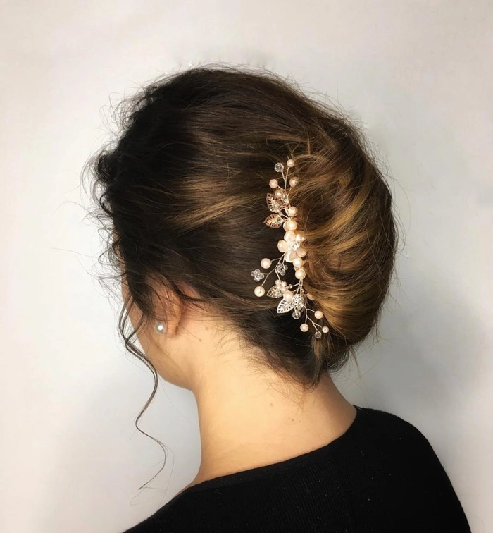 An elegant chignon hairstyle adorned with a jeweled hair comb for a date night look
