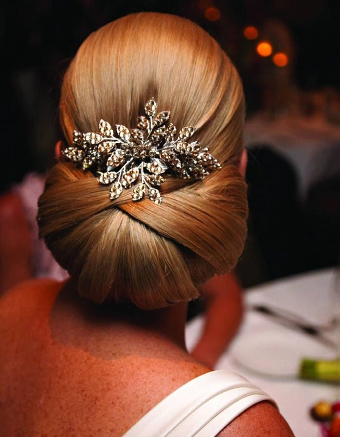 Elegant chignon updo accented with a sparkling jeweled hair comb for a romantic date night look