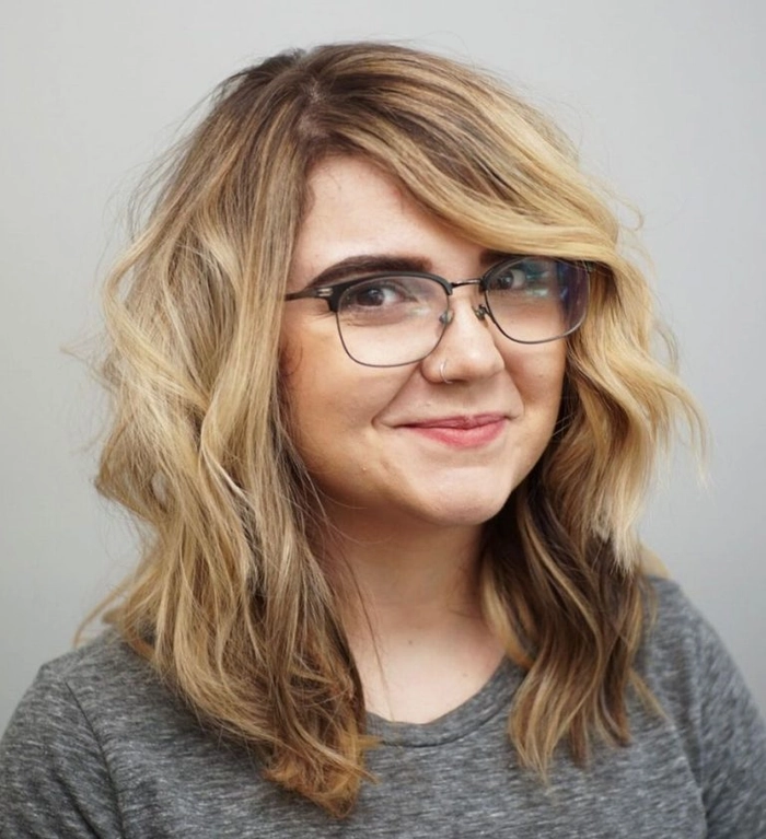 Elegant date night hairstyle featuring side swept bangs and soft waves