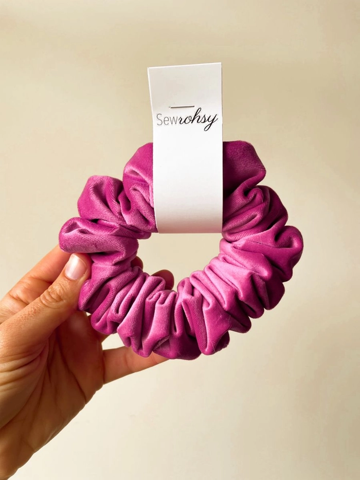 Date night hairstyle featuring a soft velvet scrunchie in a romantic updo Elegant evening updo with a black velvet scrunchie for date night