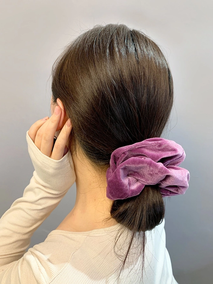 Soft waves secured with a velvet scrunchie create the perfect hairstyle for a night out Elegant evening updo featuring a black velvet scrunchie for a romantic date night look