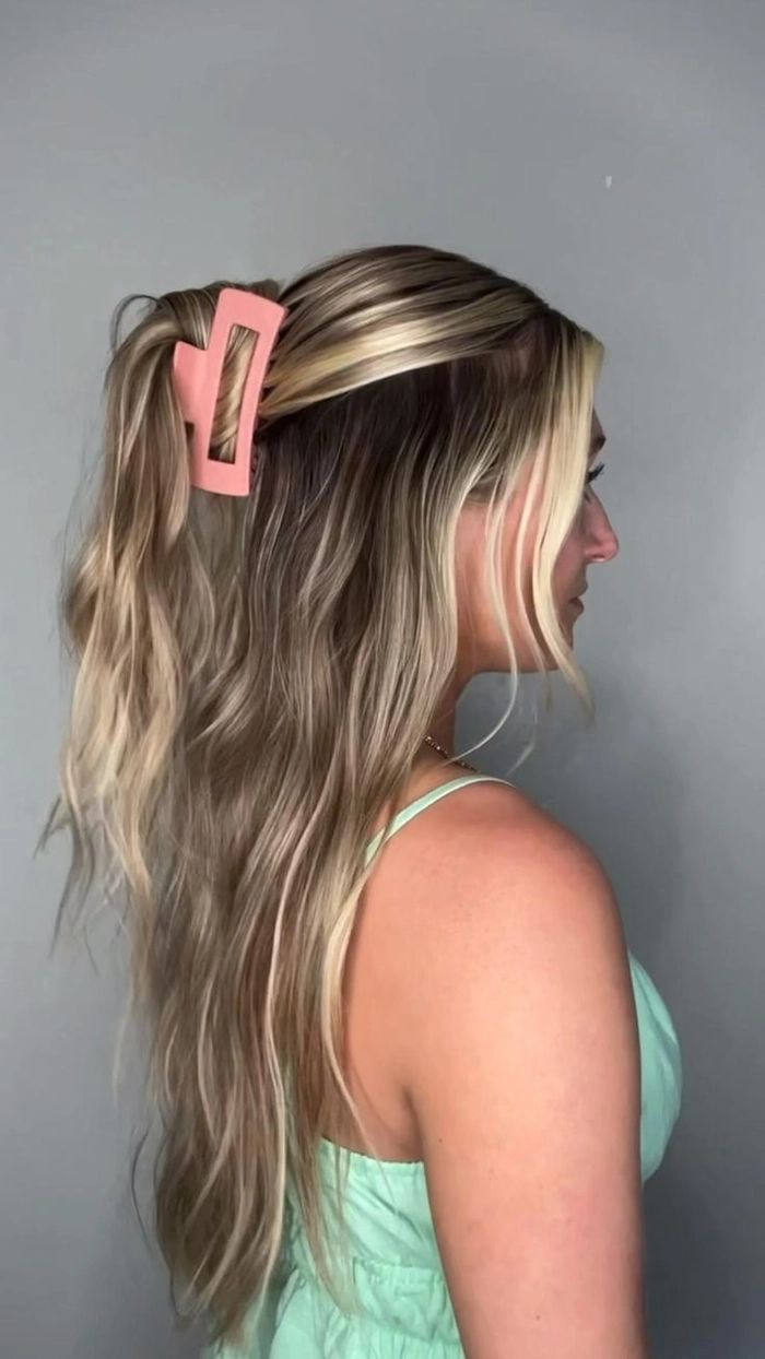 Elegant half-up hairstyle with claw clips for a romantic date night look