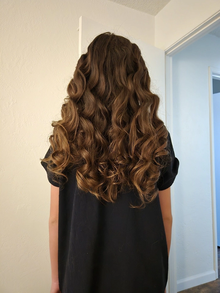 Heatless Romantic Curls for a Dreamy Date Night Look Woman with heatless romantic curls for date night, smiling softly