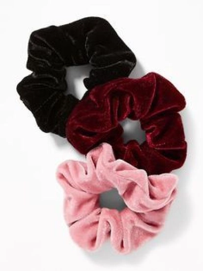 Soft velvet scrunchie accentuates a polished date night hairstyle Elegant evening updo with a deep red velvet scrunchie for a romantic date night