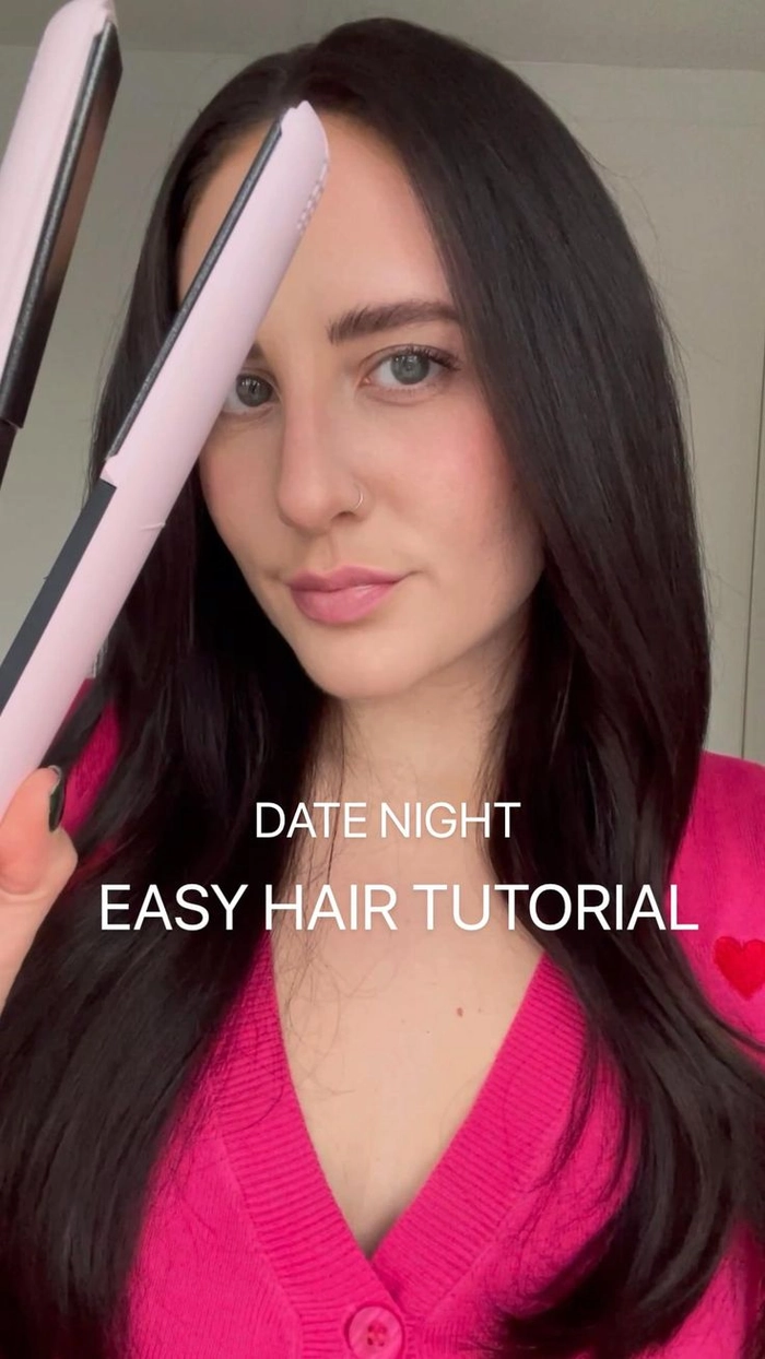 A woman quickly styling her long hair into an elegant updo for a date night in just five minutes.
