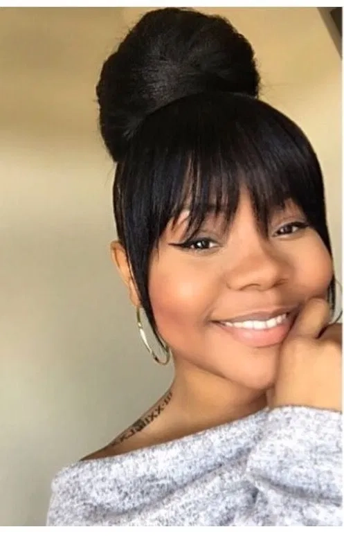 Romantic date night hairstyle for women with bangs, featuring soft waves and a side part