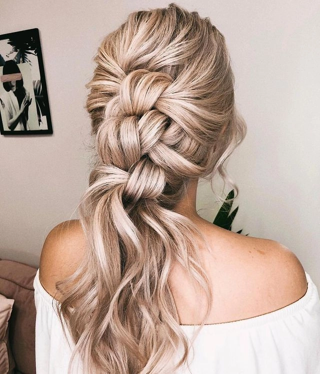 Elegant braided updo with soft waves for a romantic evening out