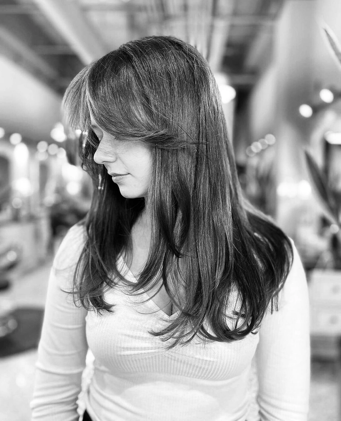 Elegant side swept bangs styled for a romantic date night, sweeping gracefully across the forehead with soft waves.