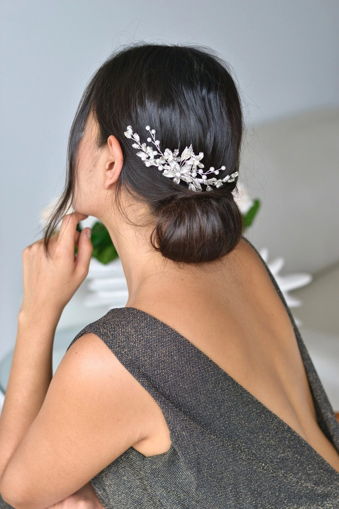 Elegant chignon hairstyle adorned with a jeweled hair comb for a romantic date night look.