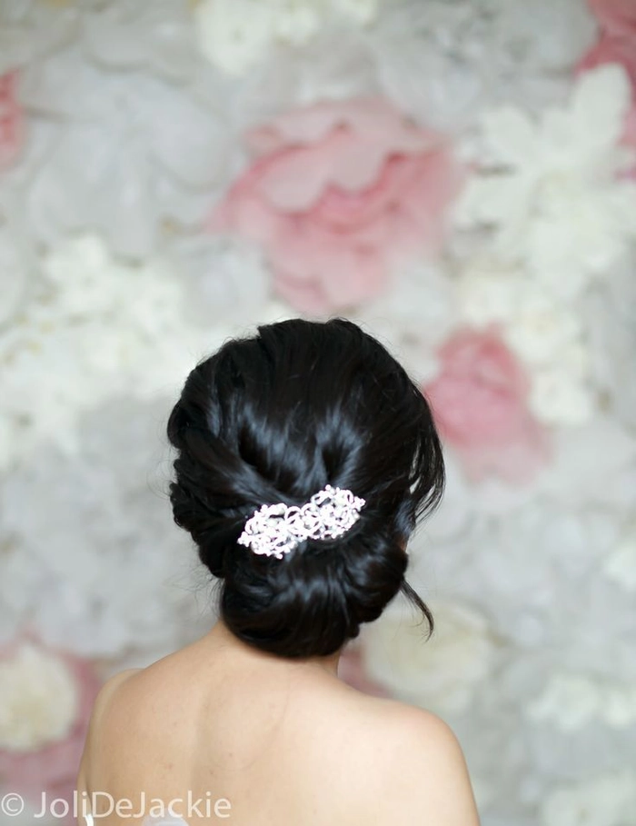 Elegant chignon hairstyle adorned with a jeweled hair comb for a date night look.