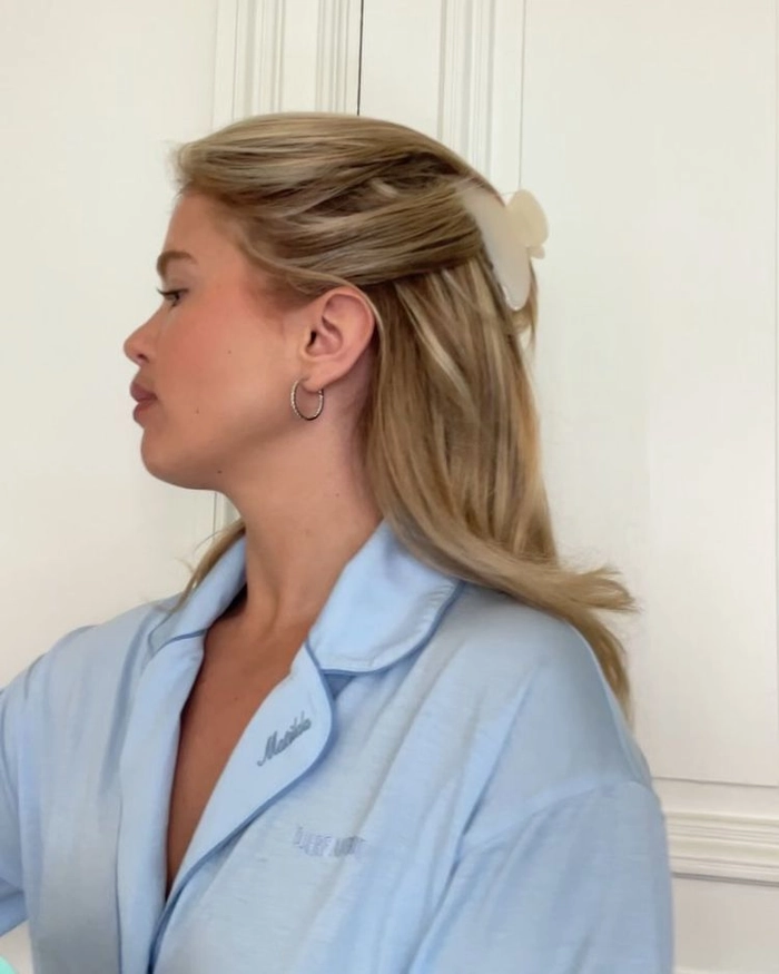 Stylish half up date night look secured with a claw clip