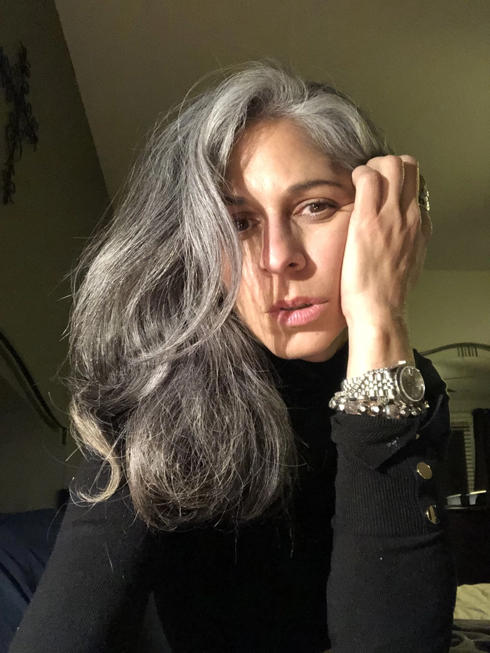 Elegant updo for silver and gray hair with soft curls perfect for a date night