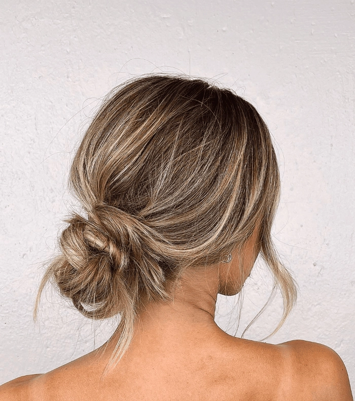 Effortless messy bun hairstyle for shoulder length hair on a romantic casual date Relaxed shoulder length messy bun perfect for a casual date night out