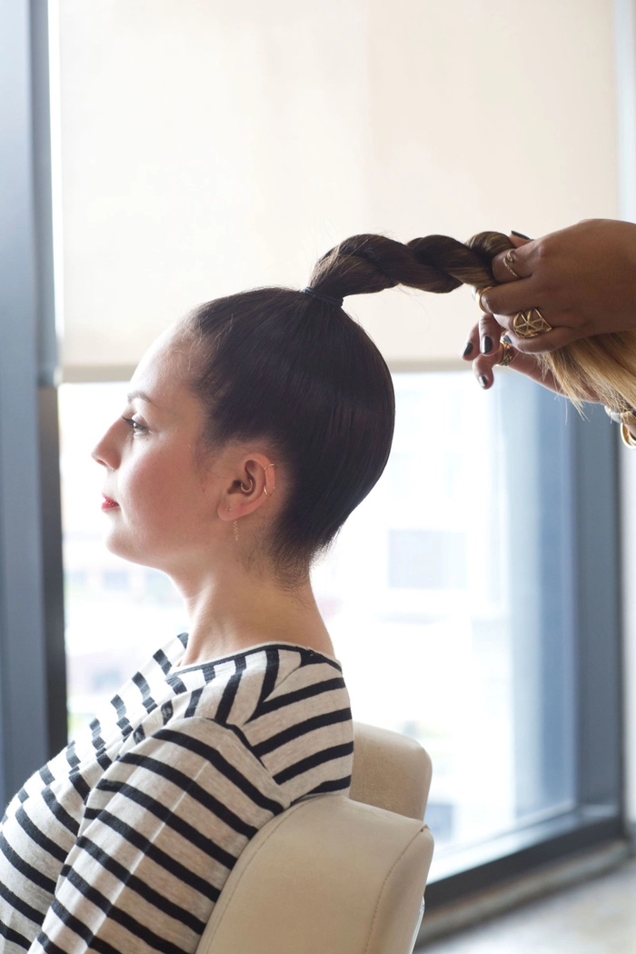 Elegant top knot perfect for a date night occasion A sophisticated top knot hairstyle suitable for an evening date event