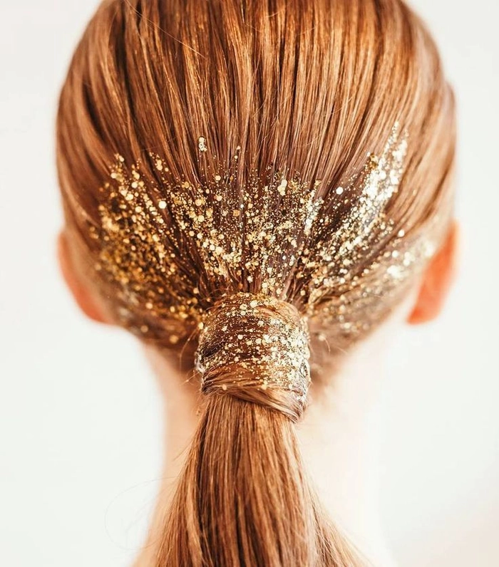 Glitter hair accents for a festive New Year's Eve date night look Close-up of New Year's Eve date night hairstyle with sparkling glitter accents