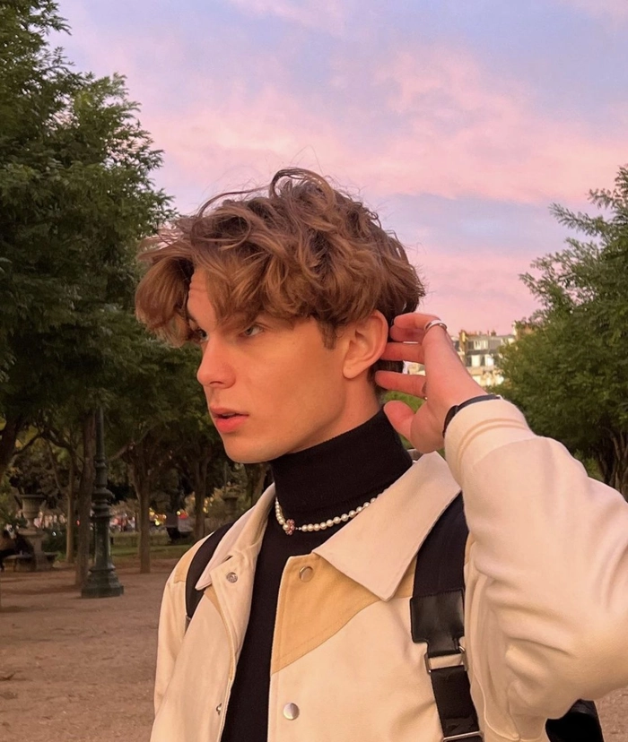 Gen Z Date Night Hair Aesthetics with Butterfly Clips and Soft Curls Young woman with half-up half-down hair featuring butterfly clips and voluminous curls for a trendy date night