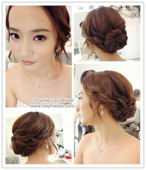 Sleek Asian evening updo with smooth finish and side-swept tendrils