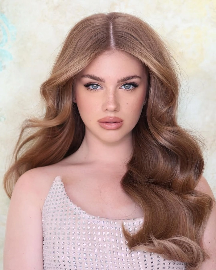 Voluminous Latina date night blowout hairstyle for a glamorous evening out Latina woman with a voluminous blowout hairstyle ready for a romantic date night